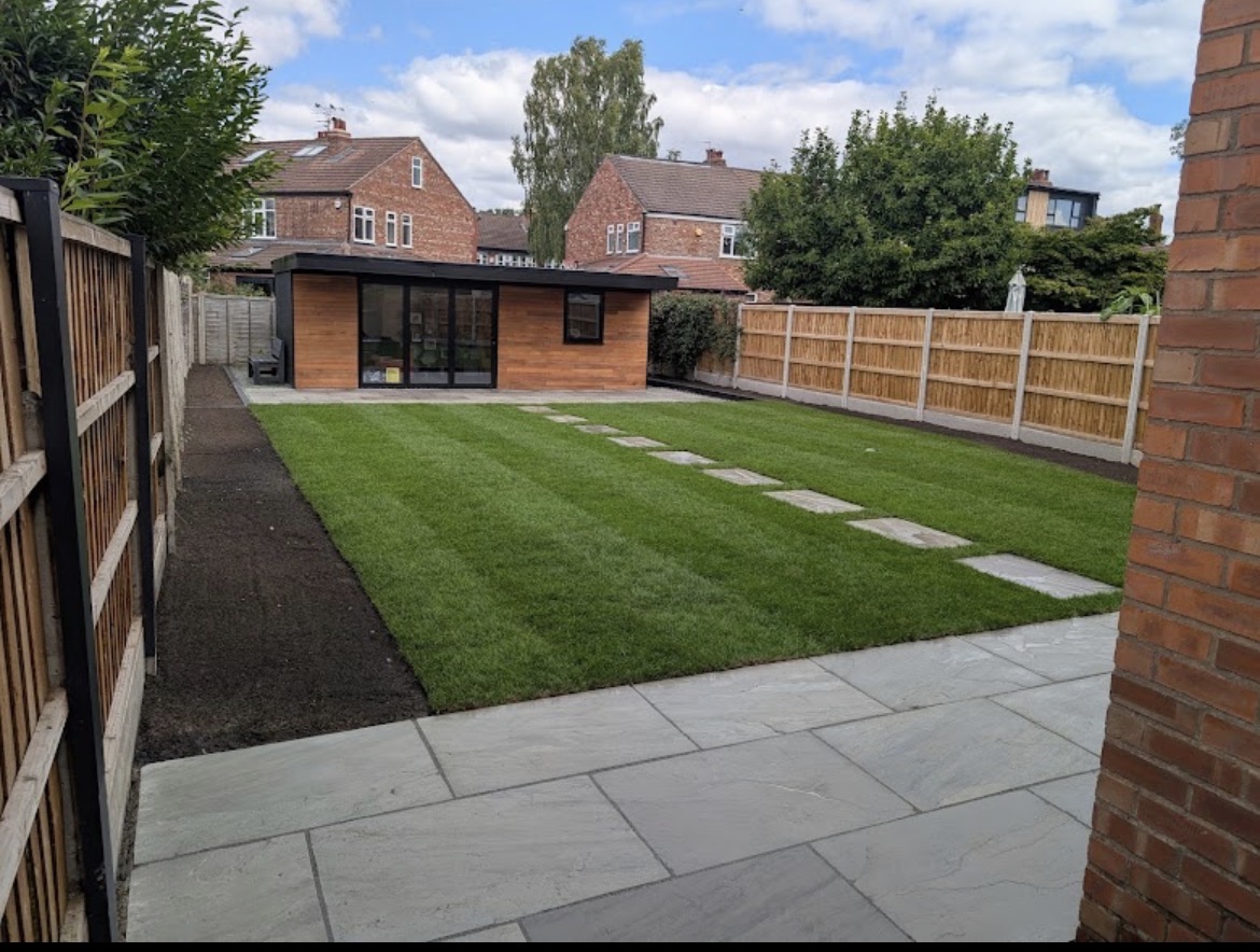 Newly laid Indian stone patio, striped lawn and garden room in a Sale back garden